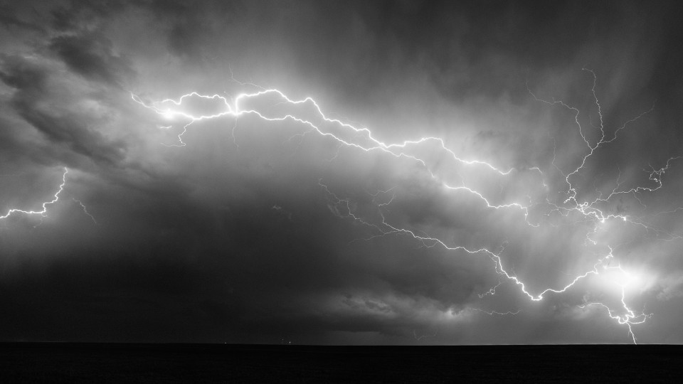 A lightning bolt seems to travel all the way across the sky and slams into the ground near Goodland, Kansas on April 15th, 2015. In reality this may have been a few different strikes unrelated to each other, but it's hard to tell. In the middle of the photo right on the horizon is a supercell and a small wall cloud that spawned a funnel cloud a bit later.