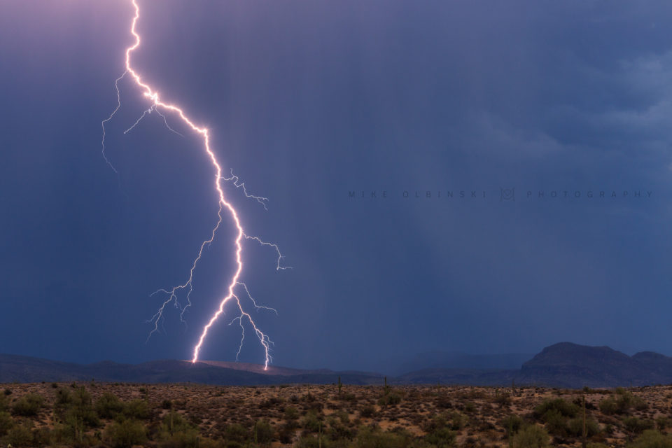 A lightning bolt lands in the Four Peaks Wilderness area northeast of Phoenix, seeming to fork into two directions at the last minute as it strikes the side of a mountain.