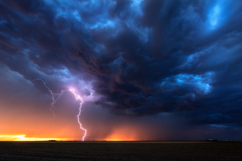 A shelf cloud slowly rolled over our position at Leoti, Kansas, revealing a gorgous sunset shining through the rain and lightning on May 30th, 2016